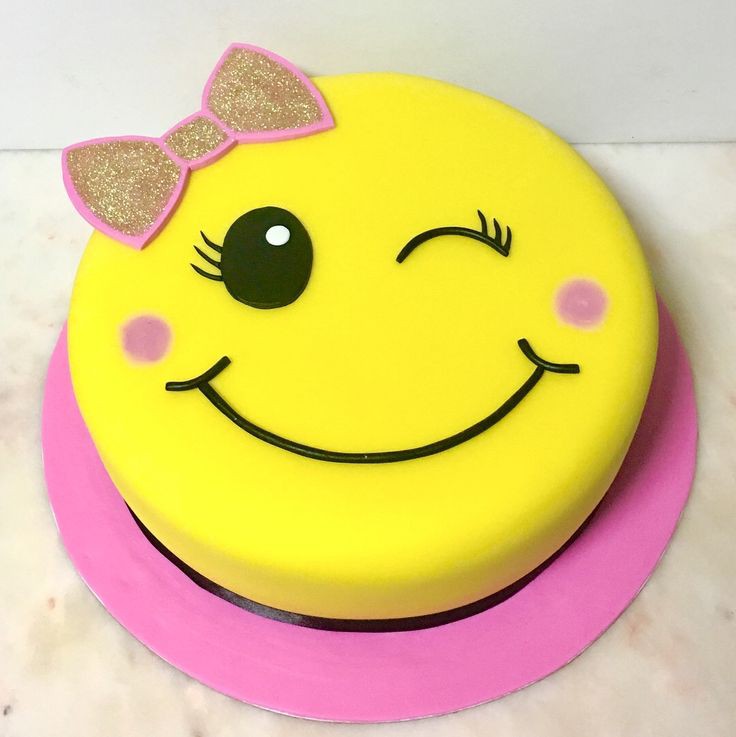 Yellow emoji smiley face cake with bow